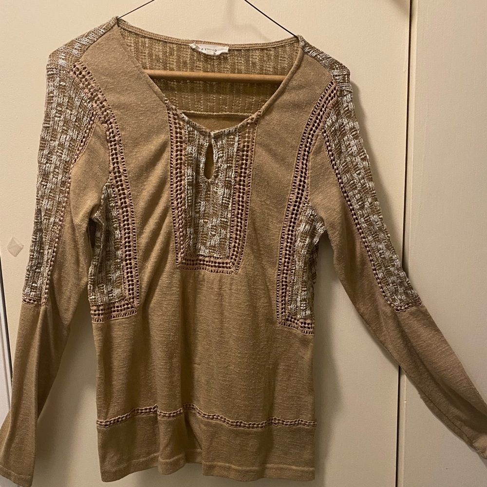 Long sleeve pullover blouse with patchwork added material.